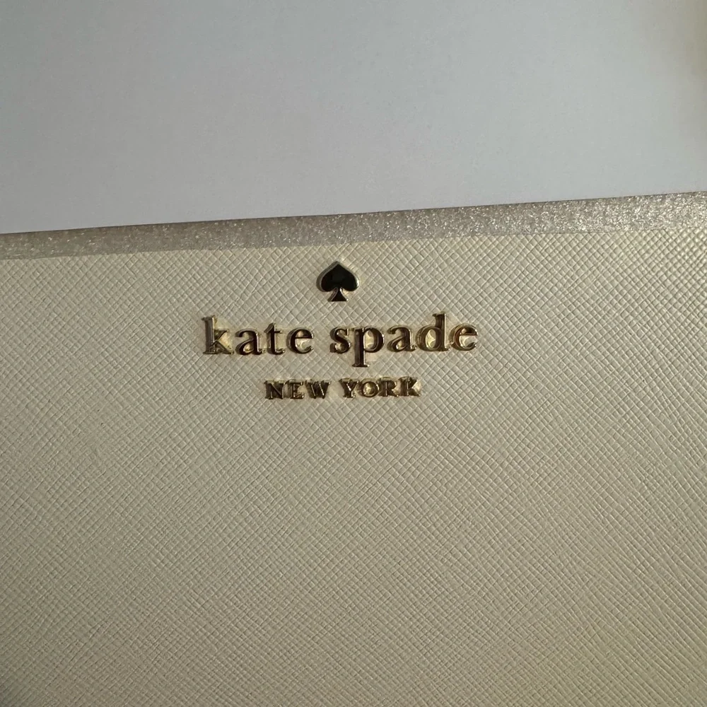 kate spade Cream Tote with Decorative Cutouts and Scarf Accent